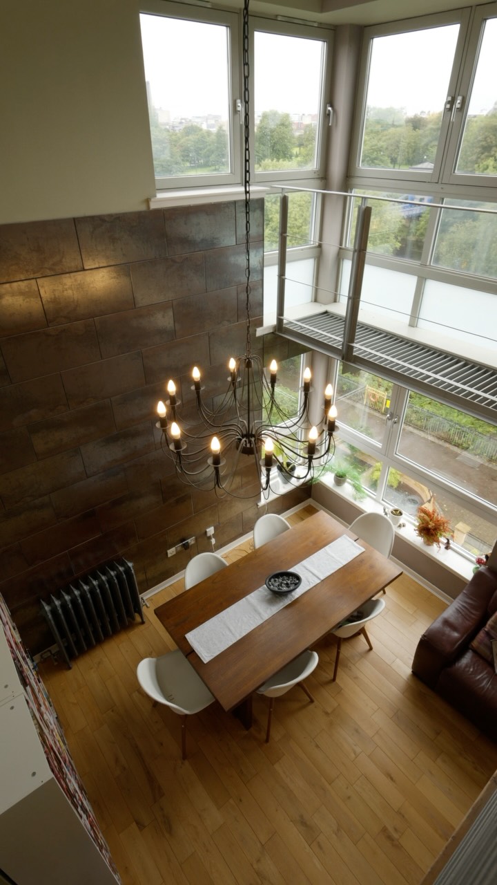 Some apartments follow the formula. This one has other ideas. It starts downstairs. Open-plan living. Dinner around the 